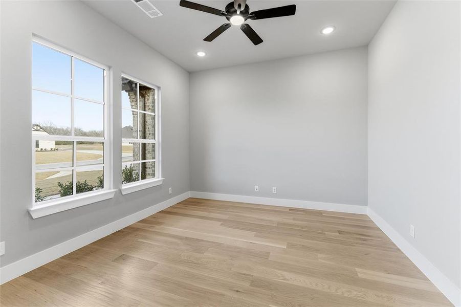 Spare room with light wood-type flooring, ceiling fan, and recessed lighting