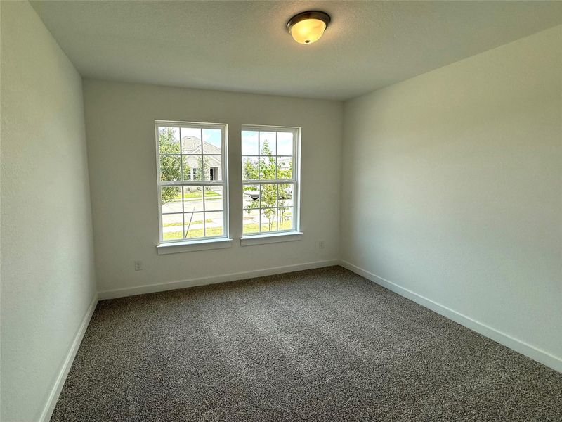 Spare room featuring carpet floors and baseboards Spare room featuring carpet floors and baseboards