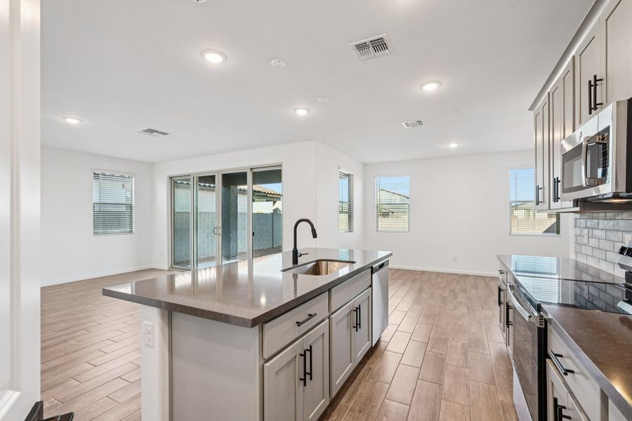 Great room, kitchen and dining. Finishes and options may vary.