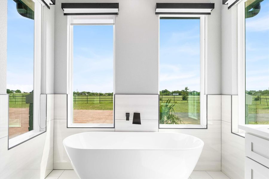 Full bath with a freestanding bath, vanity, and tile patterned flooring Full bath with a freestanding bath, vanity, and tile patterned flooring