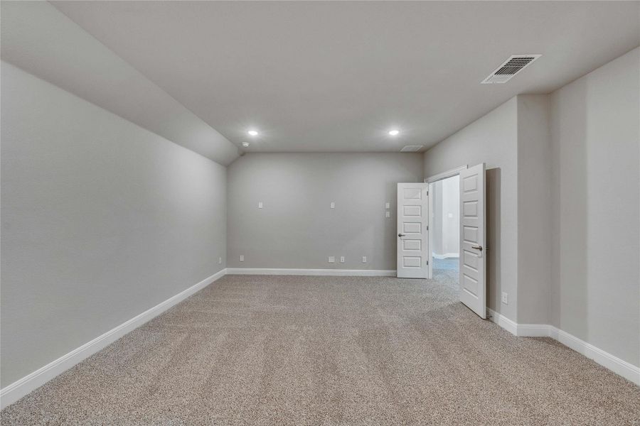 Spare room with light colored carpet and recessed lighting Spare room with light colored carpet and recessed lighting