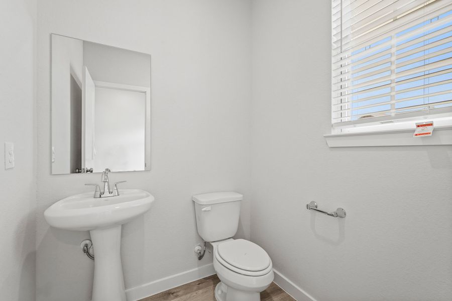 A bathroom with a toilet and sink.