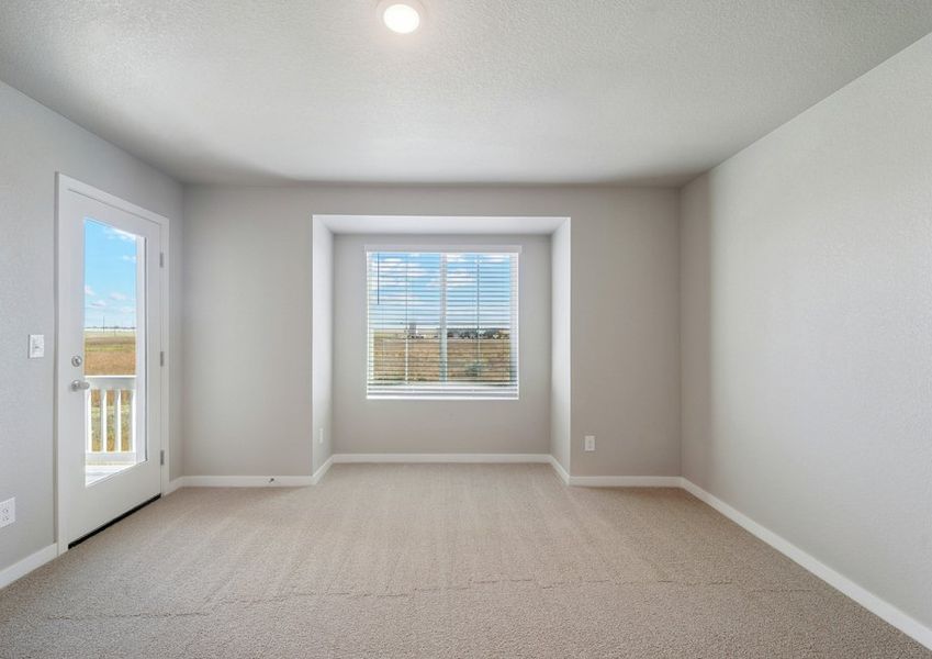 The master bedroom is spacious and has access to a deck.