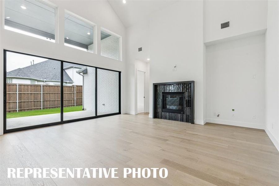 Featuring beautiful flooring, high ceilings and a full wall sliding door, the entire family will love everything this family has to offer! REPRESENTATIVE PHOTO.