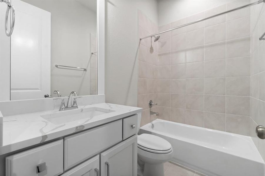 Guest bathroom with shower/tub combo.