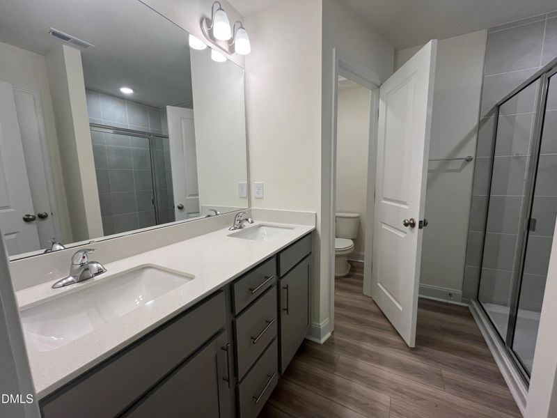 Lot 16 Dual vanities and water closet in