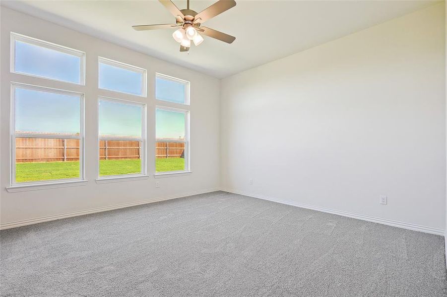 Empty room with carpet flooring and ceiling fan