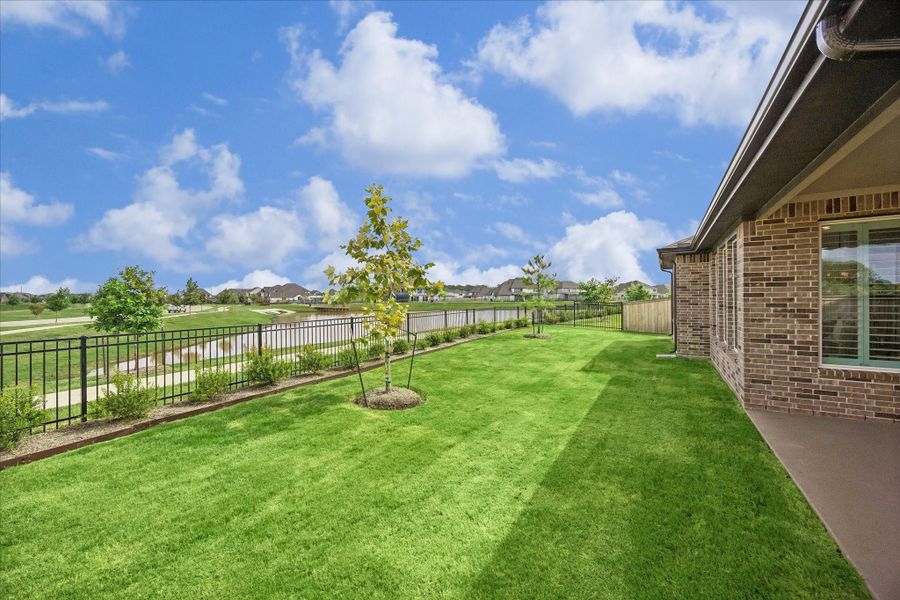 Beautiful backyard views of the water and trails. Backyard features professional landscaping, sprinkler system, full home gutters and private gate access to walking path.