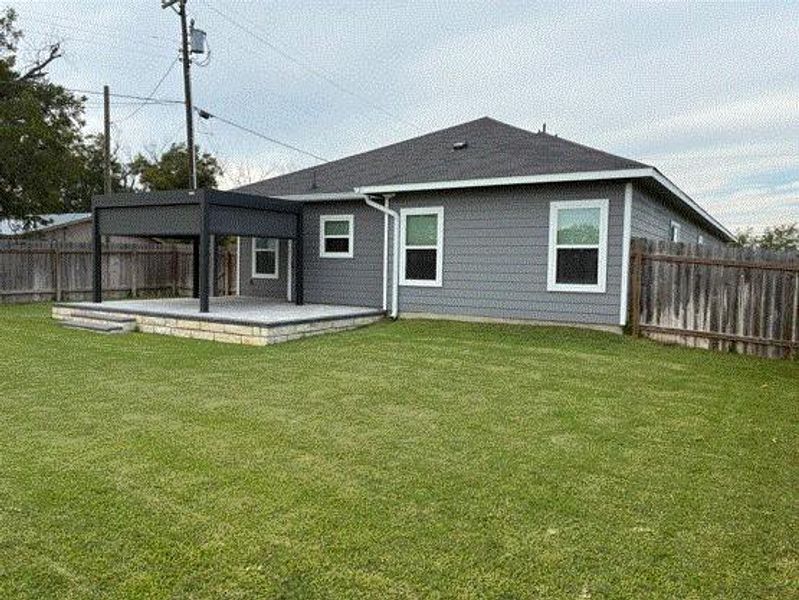 Rear view of house with a fenced backyard