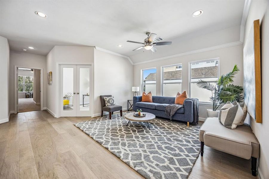 Bathed in natural light, the game room stands at the ready adjacent to glass-inset doors to the study.