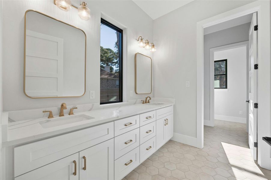 Bathroom featuring tile patterned flooring and vanity