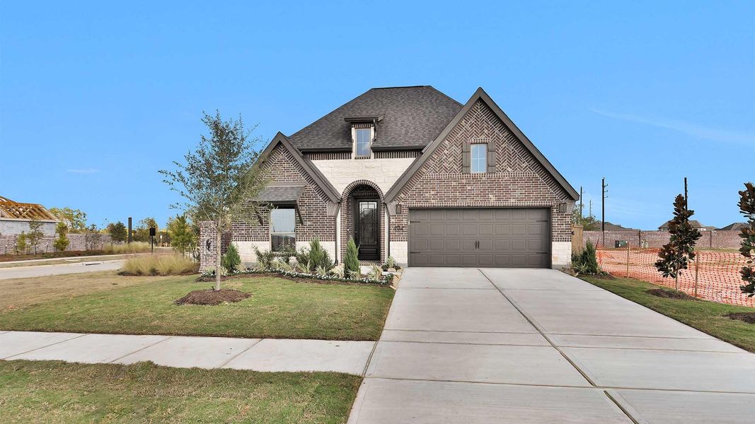 Front exterior of a new home in Grange 50', Katy, TX, highlighting curb appeal (Image 1).