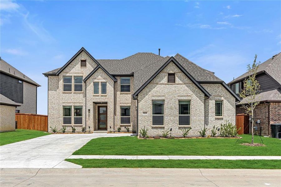 Front exterior of a new home in Timberbrook 4B, Justin, TX, highlighting curb appeal (Image 1).