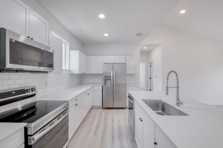A well-appointed kitchen features stainless steel appliances, ample counter space, and modern cabinetry. A well-appointed kitchen features stainless steel appliances, ample counter space, and modern cabinetry.