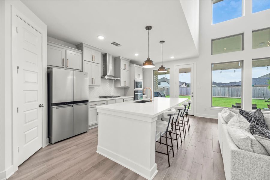 From morning coffee to midnight snacks, the oversized island offers the perfect spot for a quick bite, a visit with the family chef, or gathering with friends while the conversation flows as effortlessly as the open floor plan around you.