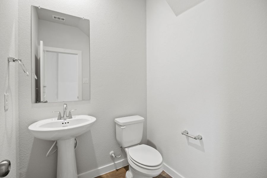 A bathroom with a sink and toilet.