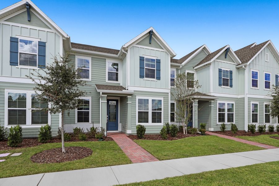 Front exterior of a new home in Shearwater: Shearwater 24ft Townhomes, St. Augustine, FL, highlighting curb appeal (Image 1).