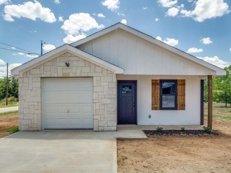 View of front of home with a garage and an outdoor structure View of front of home with a garage and an outdoor structure
