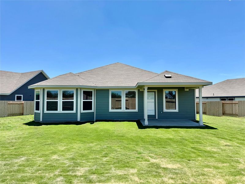Back of property with a fenced backyard and roof with shingles Back of property with a fenced backyard and roof with shingles
