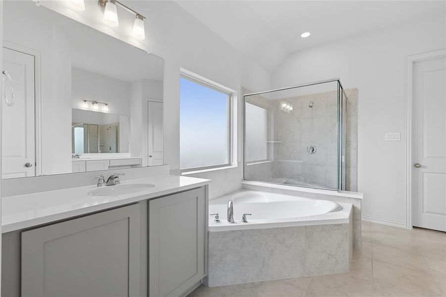 Bathroom with a shower stall, vanity, a garden tub, and recessed lighting Bathroom with a shower stall, vanity, a garden tub, and recessed lighting