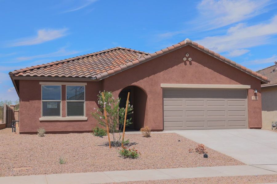 Front exterior of a new home in Entrada Del Pueblo at Rancho Sahuarita, Sahuarita, AZ, highlighting curb appeal (Image 1).