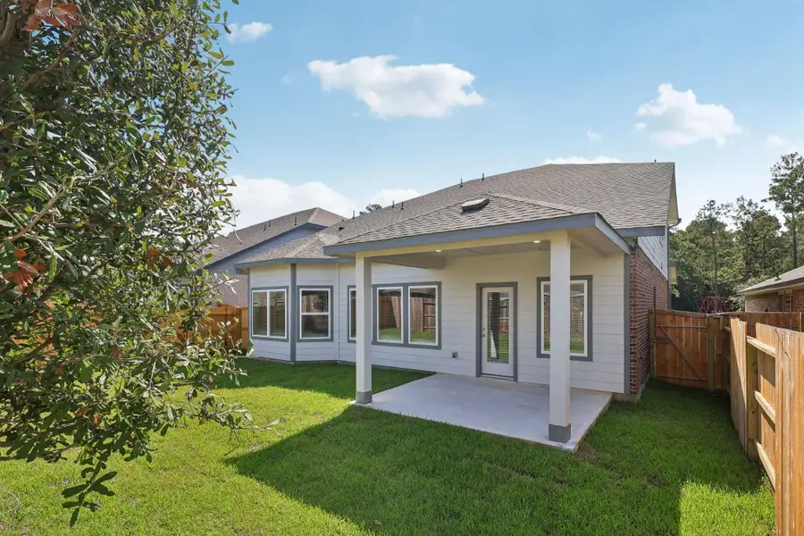 Front exterior of a new home in Stewart's Ranch, Conroe, TX, highlighting curb appeal (Image 2).