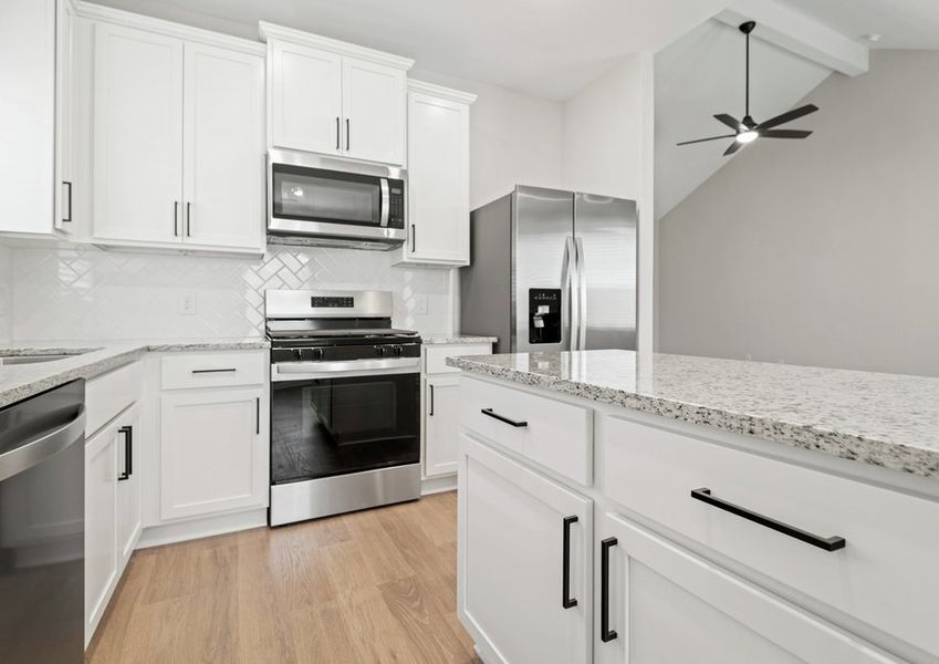 Kitchen with tile backsplash, granite countertops and matte black hardware. Kitchen with tile backsplash, granite countertops and matte black hardware.