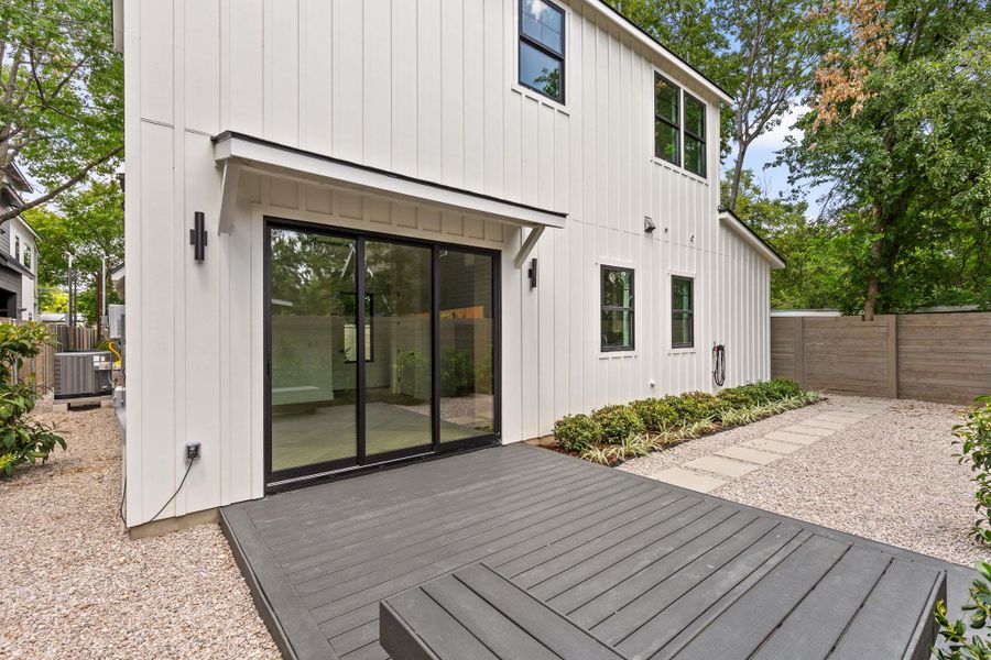Back of house featuring board and batten siding and a deck Back of house featuring board and batten siding and a deck