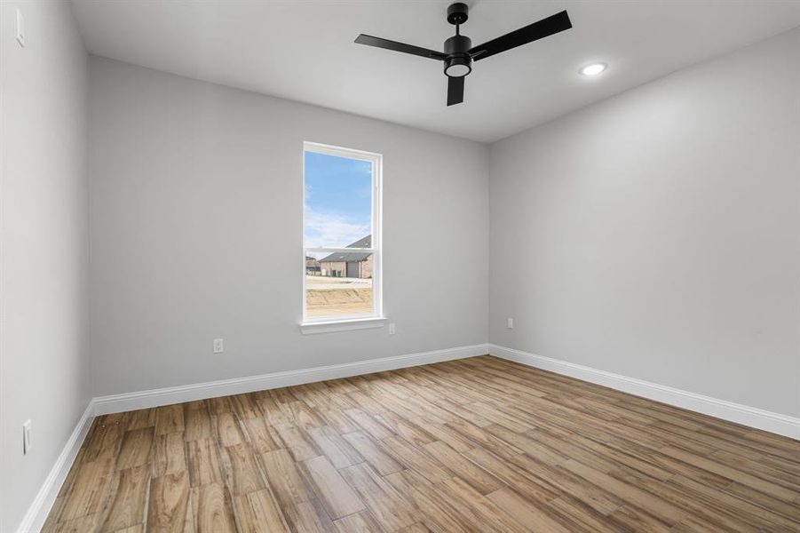 Unfurnished room with light hardwood / wood-style flooring and ceiling fan