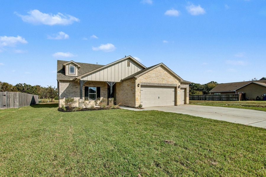 Front exterior of a new home in Columbia Lakes, West Columbia, TX, highlighting curb appeal (Image 20).