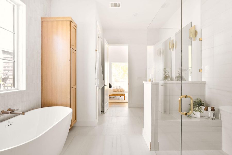 Bathroom featuring a freestanding tub and a shower stall Bathroom featuring a freestanding tub and a shower stall