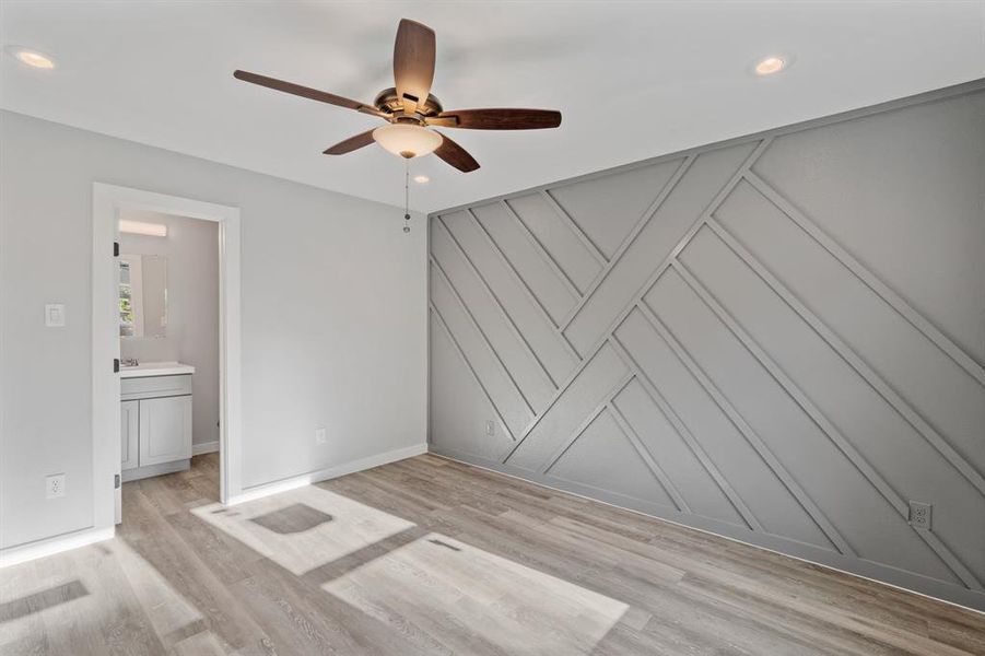 Empty room with light hardwood / wood-style floors and ceiling fan