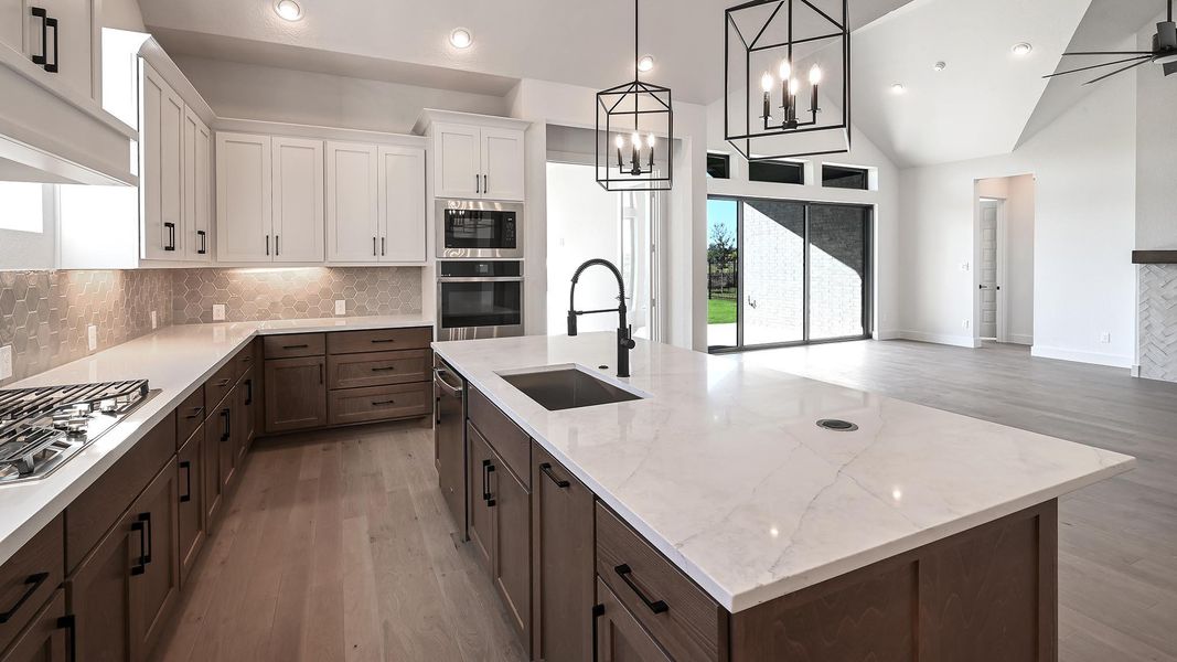Kitchen with backsplash, dark brown cabinetry, light wood finished floors, white cabinetry, and recessed lighting Kitchen with backsplash, dark brown cabinetry, light wood finished floors, white cabinetry, and recessed lighting