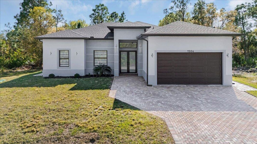 Front exterior of a new home in , Lehigh Acres, FL, highlighting curb appeal (Image 1).