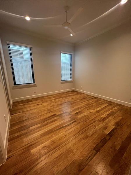 Unfurnished room with hardwood / wood-style floors, ceiling fan, and ornamental molding