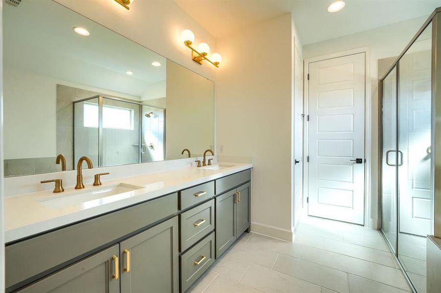 Bathroom featuring vanity and an enclosed shower