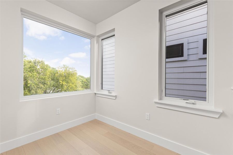 Clean lines and light-toned hardwood flooring define this versatile corner alcove.