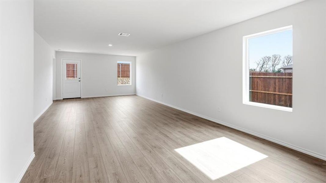Empty room with light wood-type flooring and baseboards Empty room with light wood-type flooring and baseboards