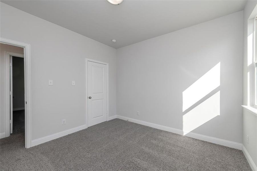 Unfurnished room featuring carpet and baseboards Unfurnished room featuring carpet and baseboards
