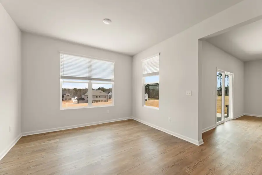 A room with a wood floor and a wood floor with a window. A room with a wood floor and a wood floor with a window.
