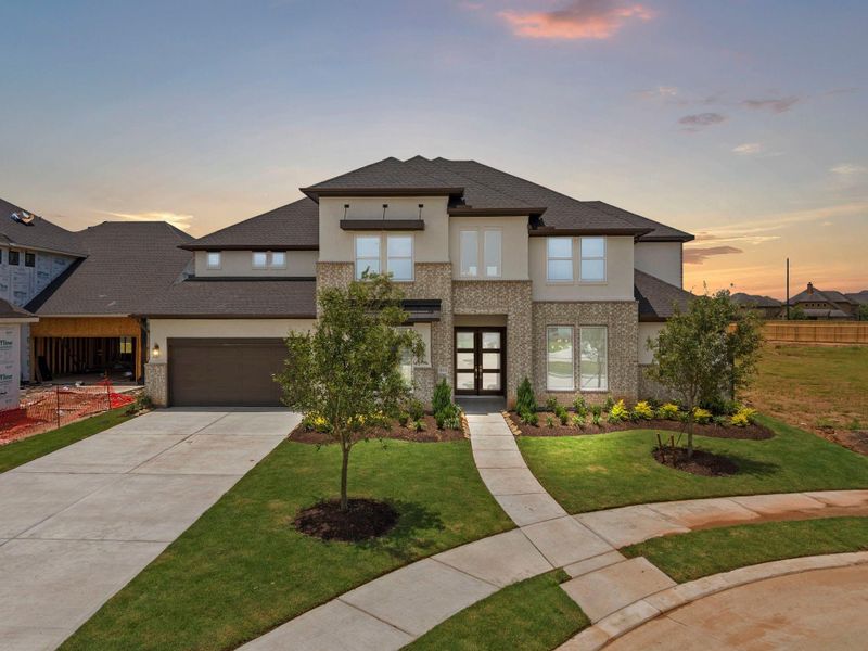 Front exterior of a new home in Harvest Green, Richmond, TX, highlighting curb appeal (Image 2). Front exterior of a new home in Harvest Green, Richmond, TX, highlighting curb appeal (Image 2).