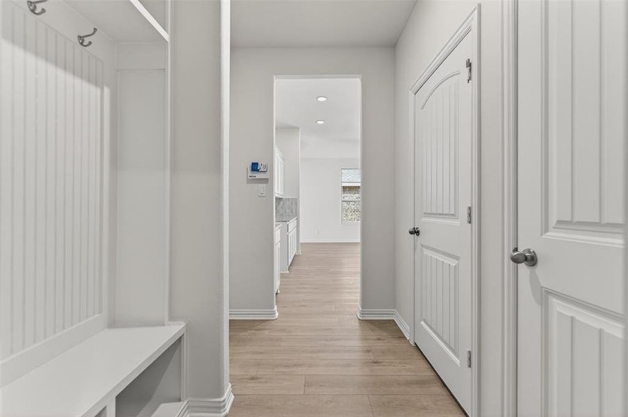 Mudroom featuring light wood-style flooring and recessed lighting