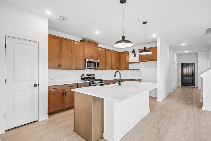 Chef-worthy kitchen with light stain cabinets