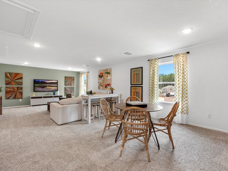 A large living room with a large dining table and couches.