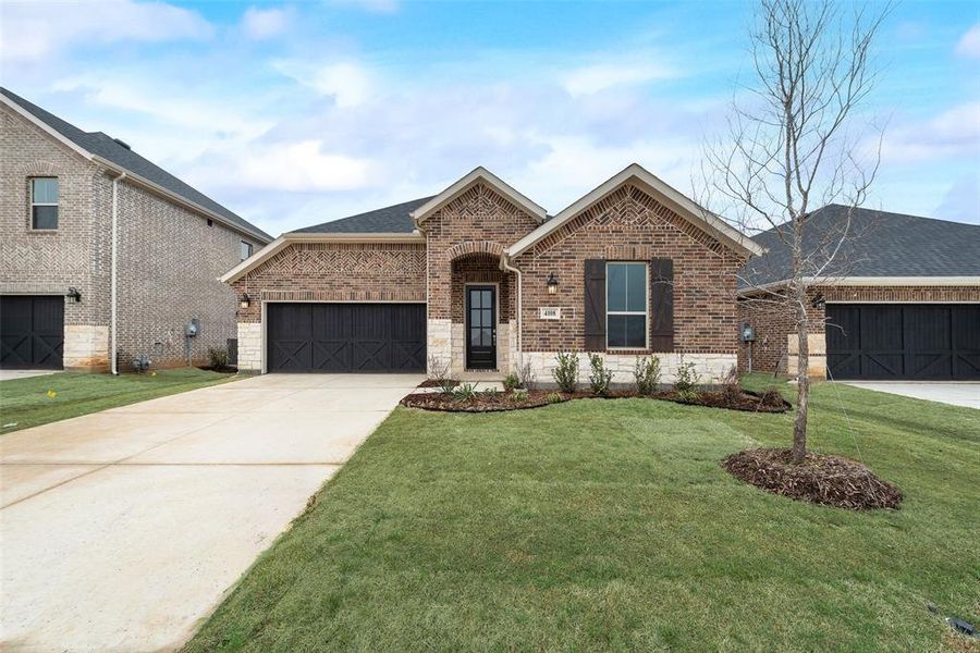 Front exterior of a new home in Spiritas Ranch, Little Elm, TX, highlighting curb appeal (Image 18).