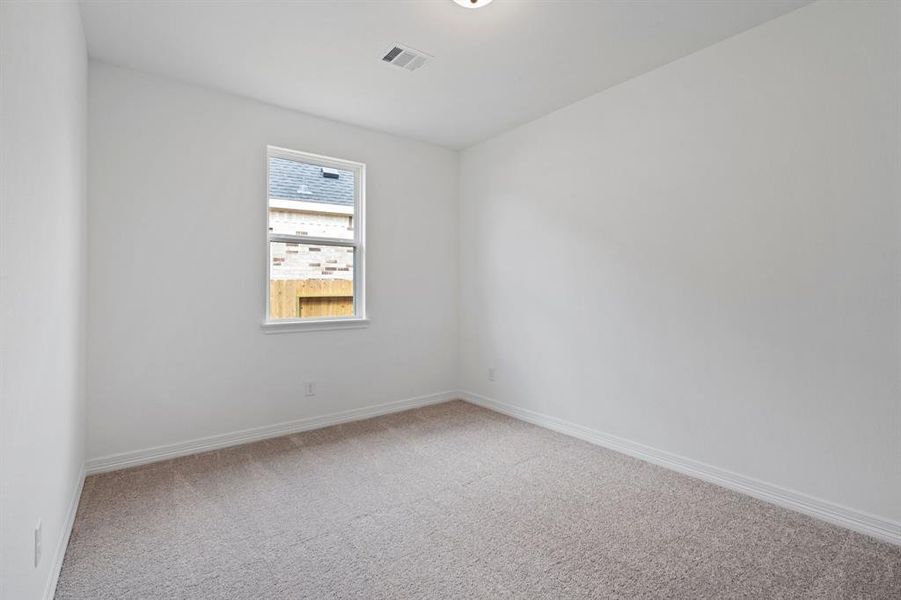 Your secondary bedroom features plush carpet, fresh paint, closet, and a large window that lets in plenty of natural lighting.