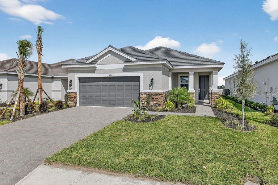 Front exterior of a new home in Coasterra Community Group Page, Palmetto, FL, highlighting curb appeal (Image 22).