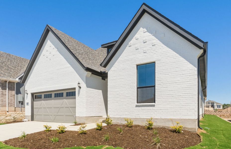 Front exterior of a new home in Sun City Texas, Georgetown, TX, highlighting curb appeal (Image 19).