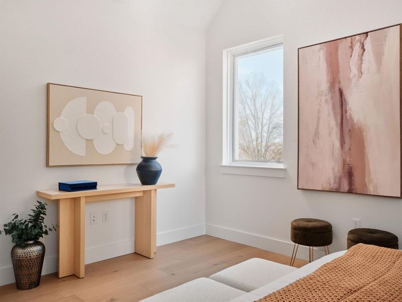 Bedroom featuring light wood-type flooring and baseboards