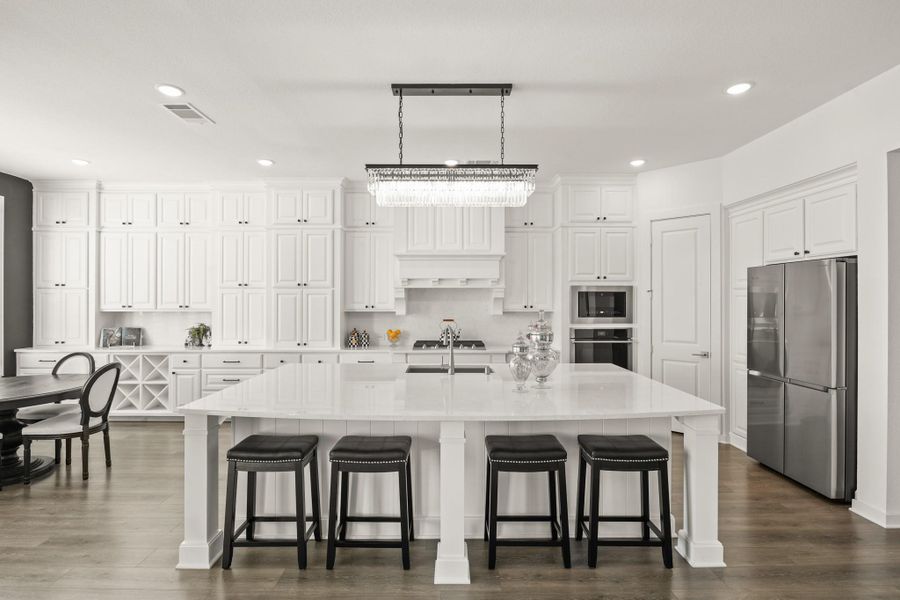 If storage is what you need, these wall-to-wall built-in cabinets extend into the breakfast area, offering soft close doors, pots and pans drawers and a second row of upper cabinets that reach the ceiling for additional storage.